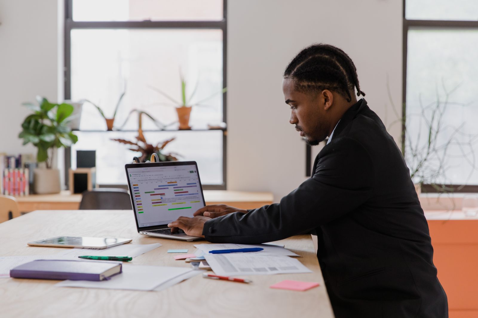 A small-business owner managing their booking calendar on a laptop