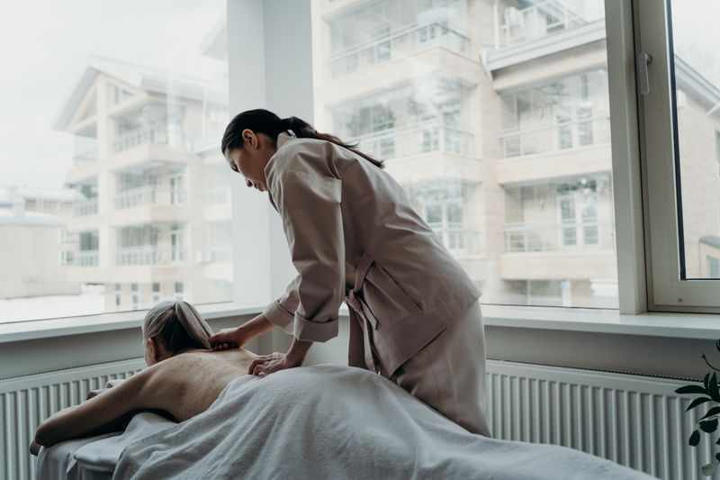 A spa therapist with a client